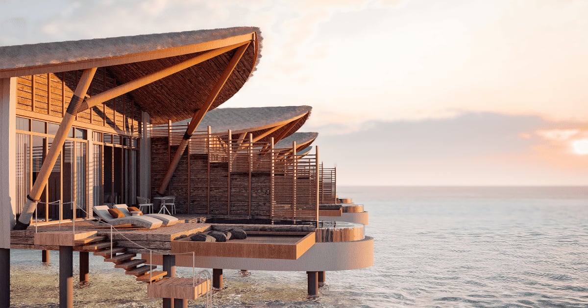 Official render of Aura Maldives overwater villas at sunset