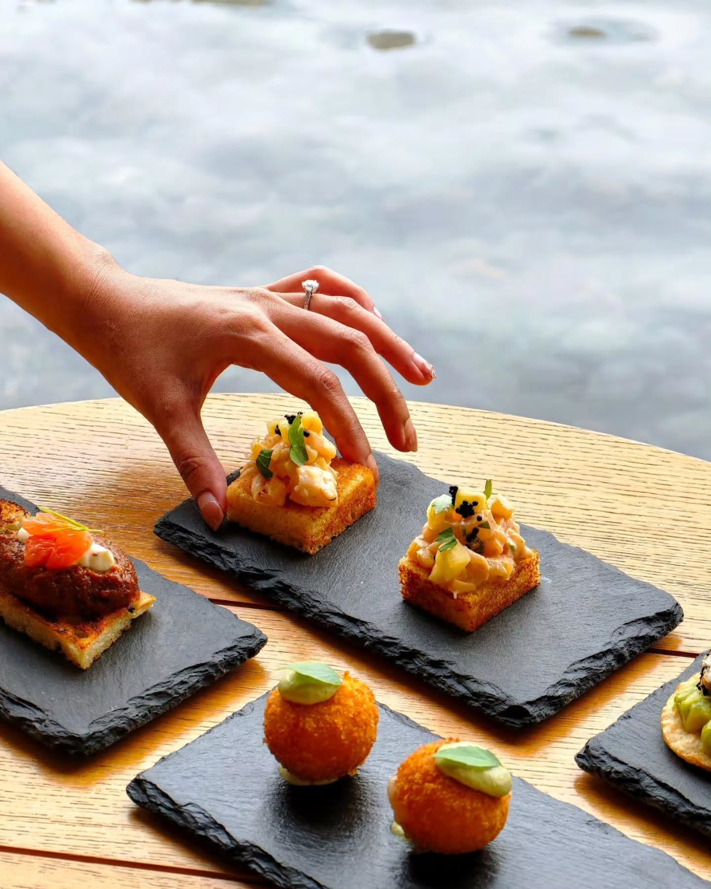 Photo by Alila Kothaifaru Maldives on June 17, 2026. May be an image of tofu, croquette, baguette, caviar, toast and text.