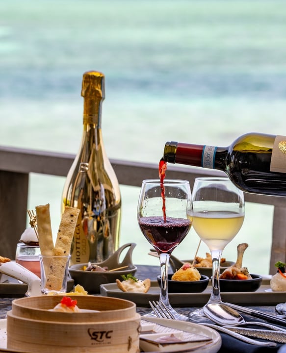 Photo by Atmosphere Kanifushi Maldives on August 11, 2026. May be an image of champagne, wine glass and text.