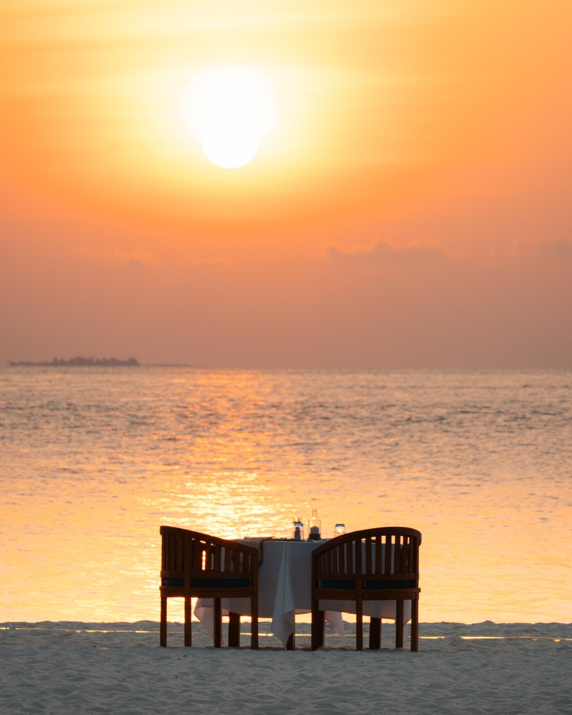Photo by Bandos Maldives on April 24, 2026. May be an image of deck chair, beach, twilight, water and text.