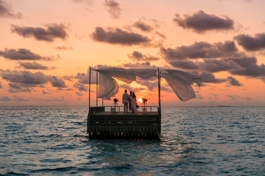 Photo by Baros Maldives on May 04, 2026. May be an image of people kissing, ocean, wedding, water and text.