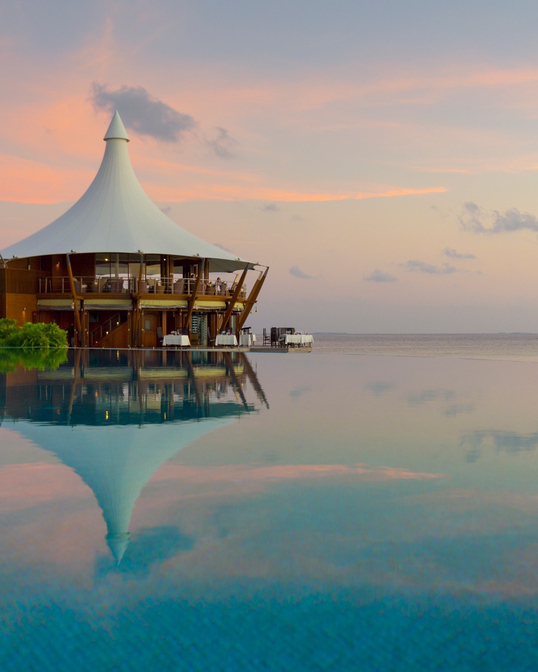 Photo by Baros Maldives on August 09, 2026. May be an image of pool, twilight, cabana and text.