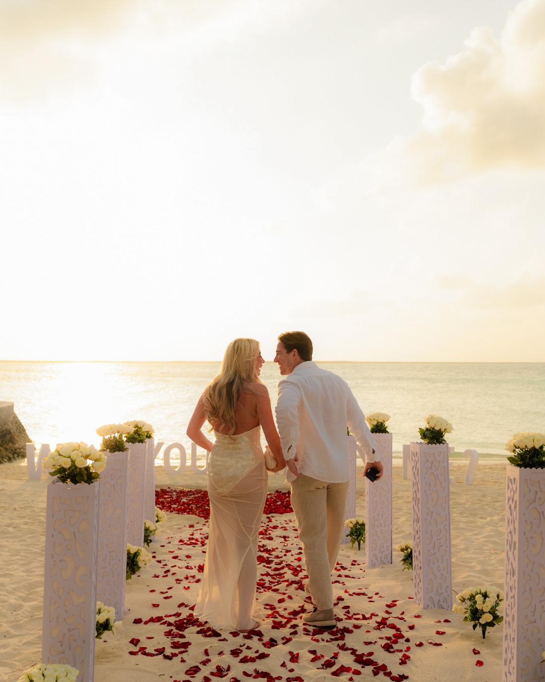 Photo shared by Centara Ras Fushi Resort & Spa Maldives on August 12, 2026 tagging @explorecentara. May be an image of people kissing, wedding and text.