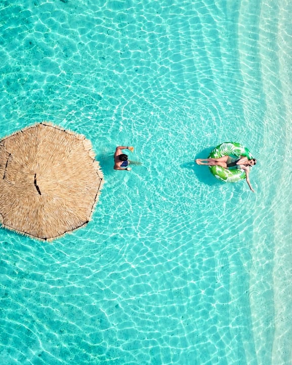 Foto condivisa da Centara Ras Fushi Resort & Spa Maldives il 09 settembre 2026 con il tag @explorecentara. Potrebbe raffigurare persone che nuotano, ombrellone, zattera, piscina e testo.