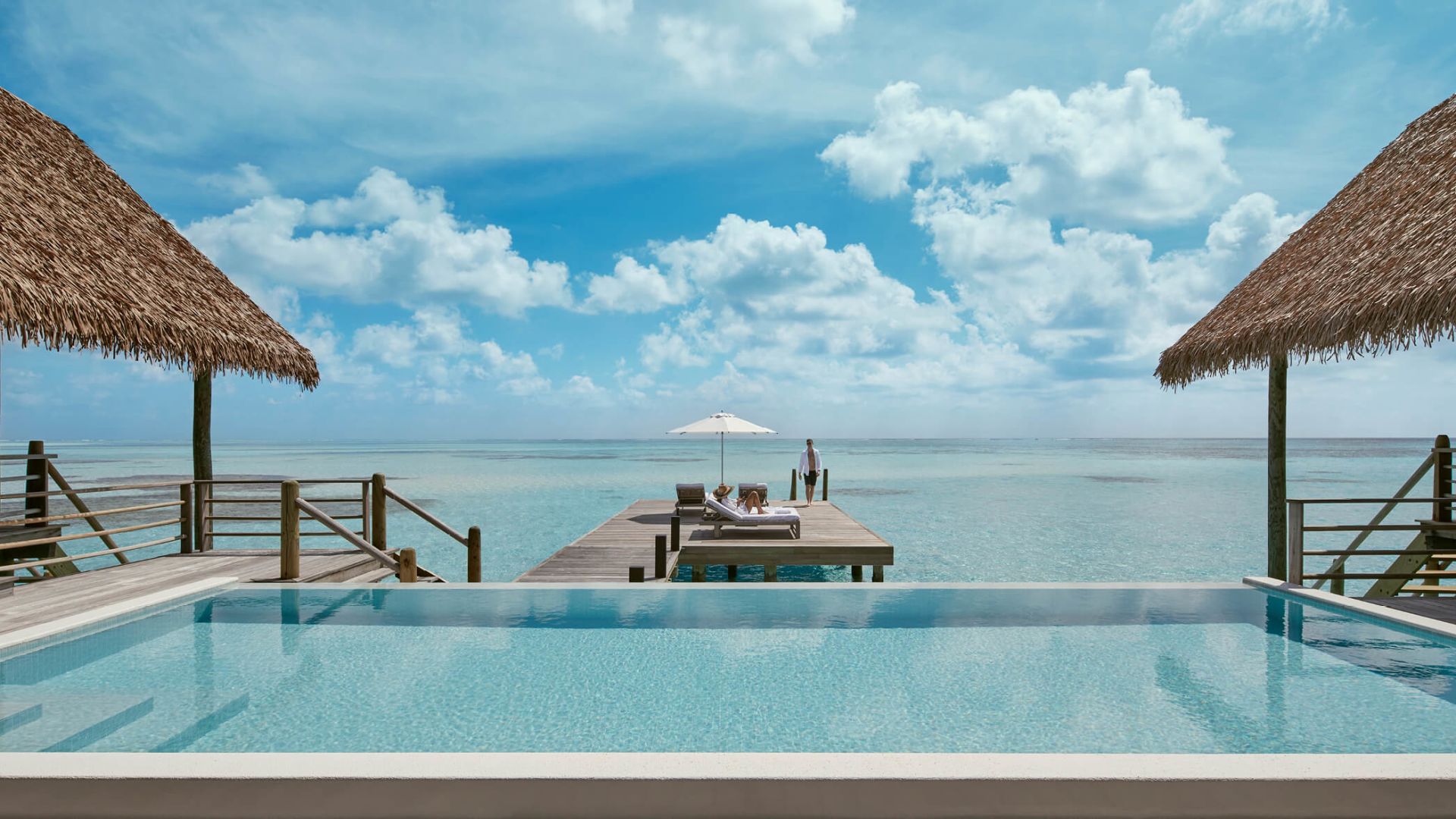 Two-Bedroom COMO Sunrise Villa — infinity pool deck overlooking the lagoon