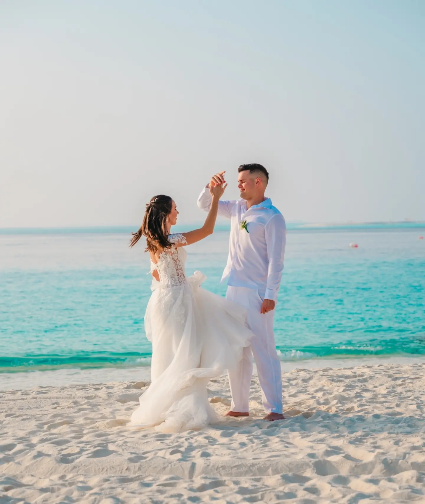 Photo shared by Fushifaru Maldives | Boutique Resort on August 11, 2026 tagging @pappzita_. May be an image of gown, wedding, beach and text.