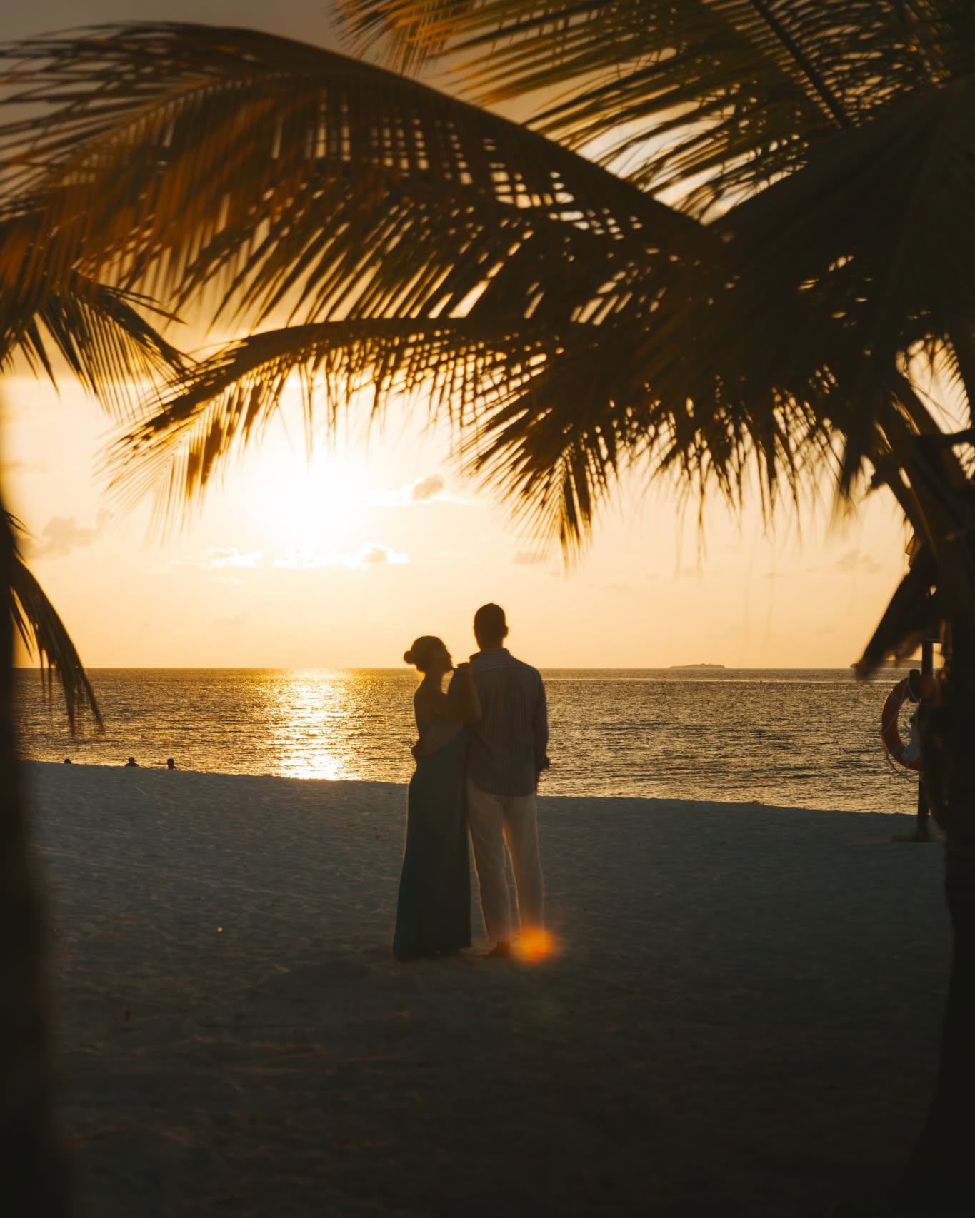 Photo by Heritance Aarah on June 18, 2026. May be an image of people kissing, beach, wedding, water, palm trees and text.