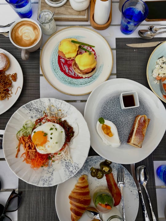 Photo shared by black diamond on August 07, 2026 tagging @huvafenfushi_maldives. May be an image of poached egg, scotch egg, egg yolk, pancake, hollandaise, buffet and text.