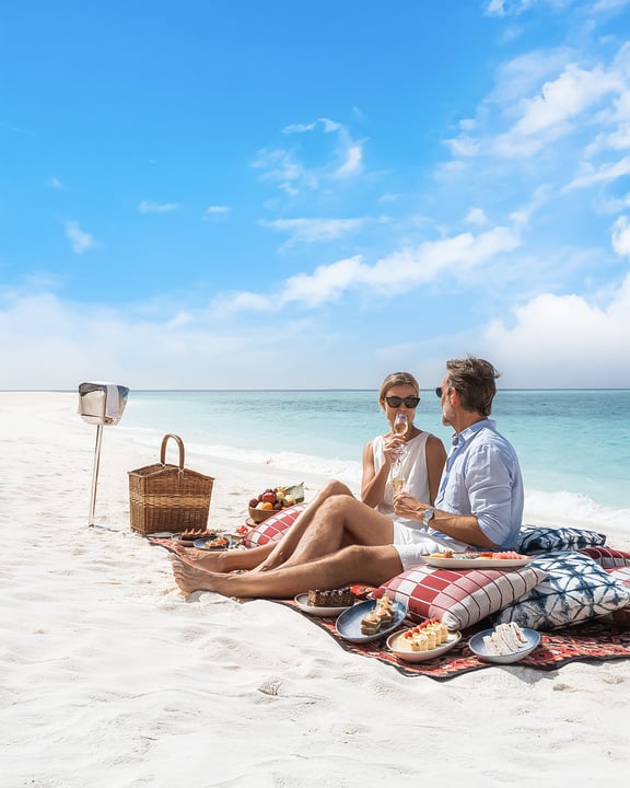 Photo by InterContinental Maldives in InterContinental Maldives Maamunagau Resort. May be an image of towel, umbrella, deck chair, picnic and text.