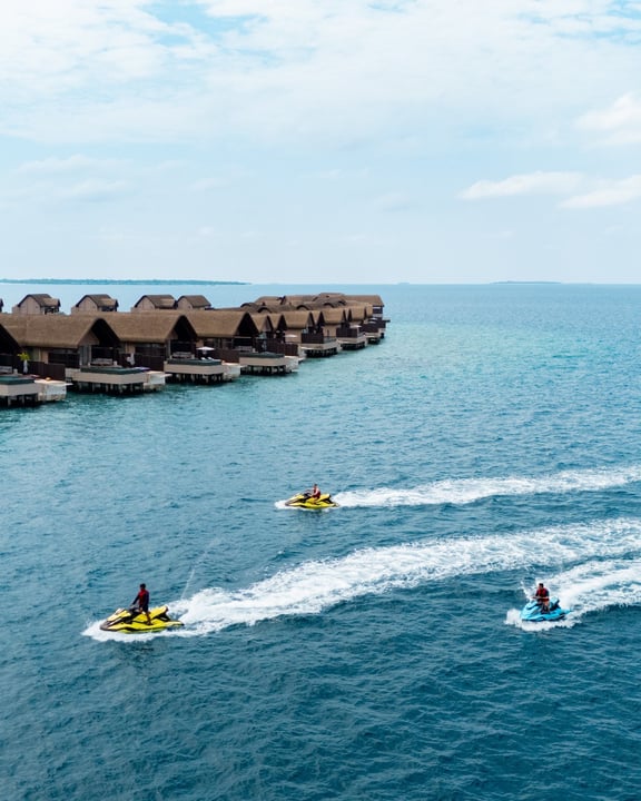 Photo by JOALI BEING in JOALI BEING. May be an image of parasail, jet ski, speedboat and text.