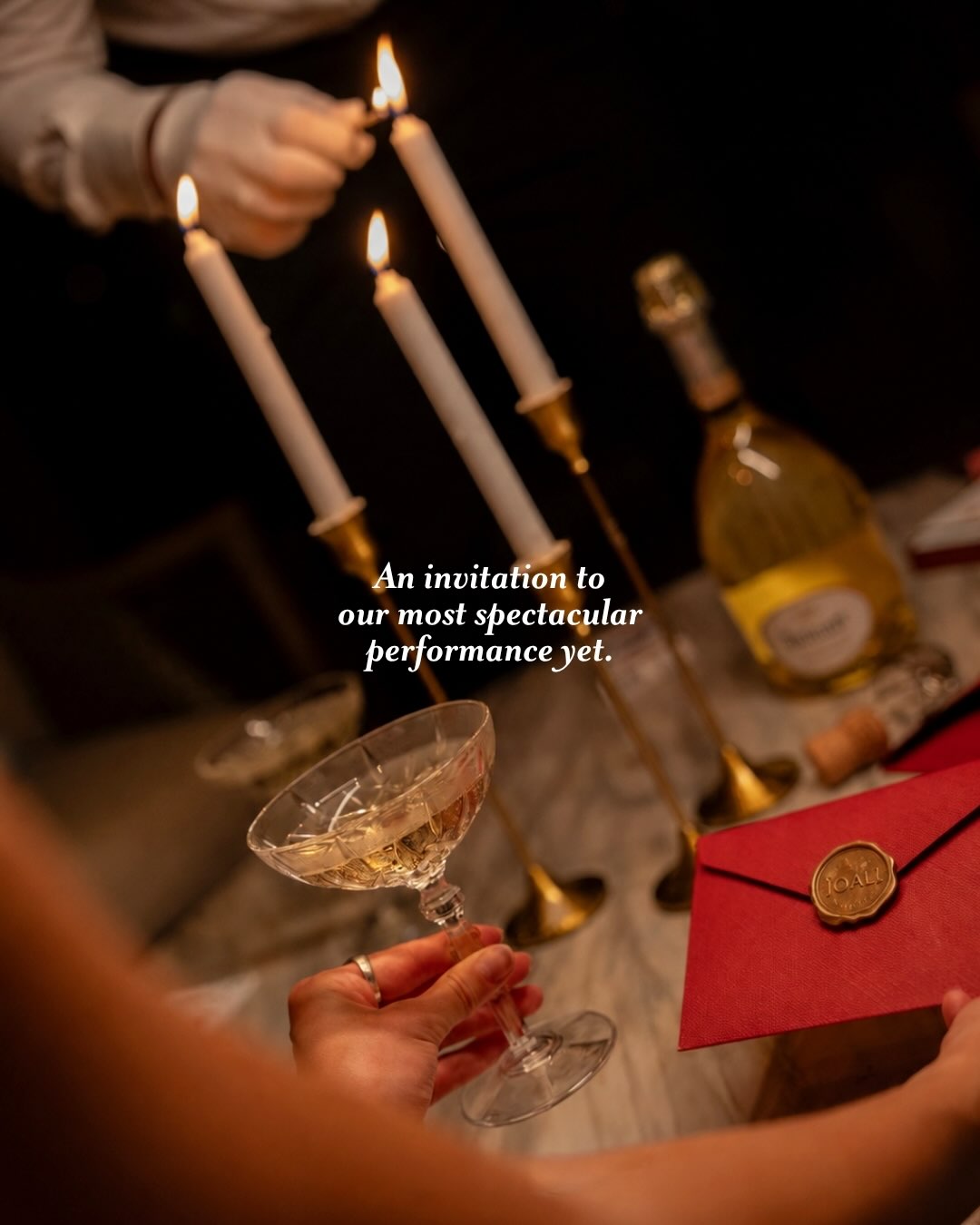 Photo by JOALI Maldives on August 10, 2026. May be an image of candle holder, champagne, wine glass, goblet, candle and text that says "An invitation to our most spectacular performanceyet. yet.".