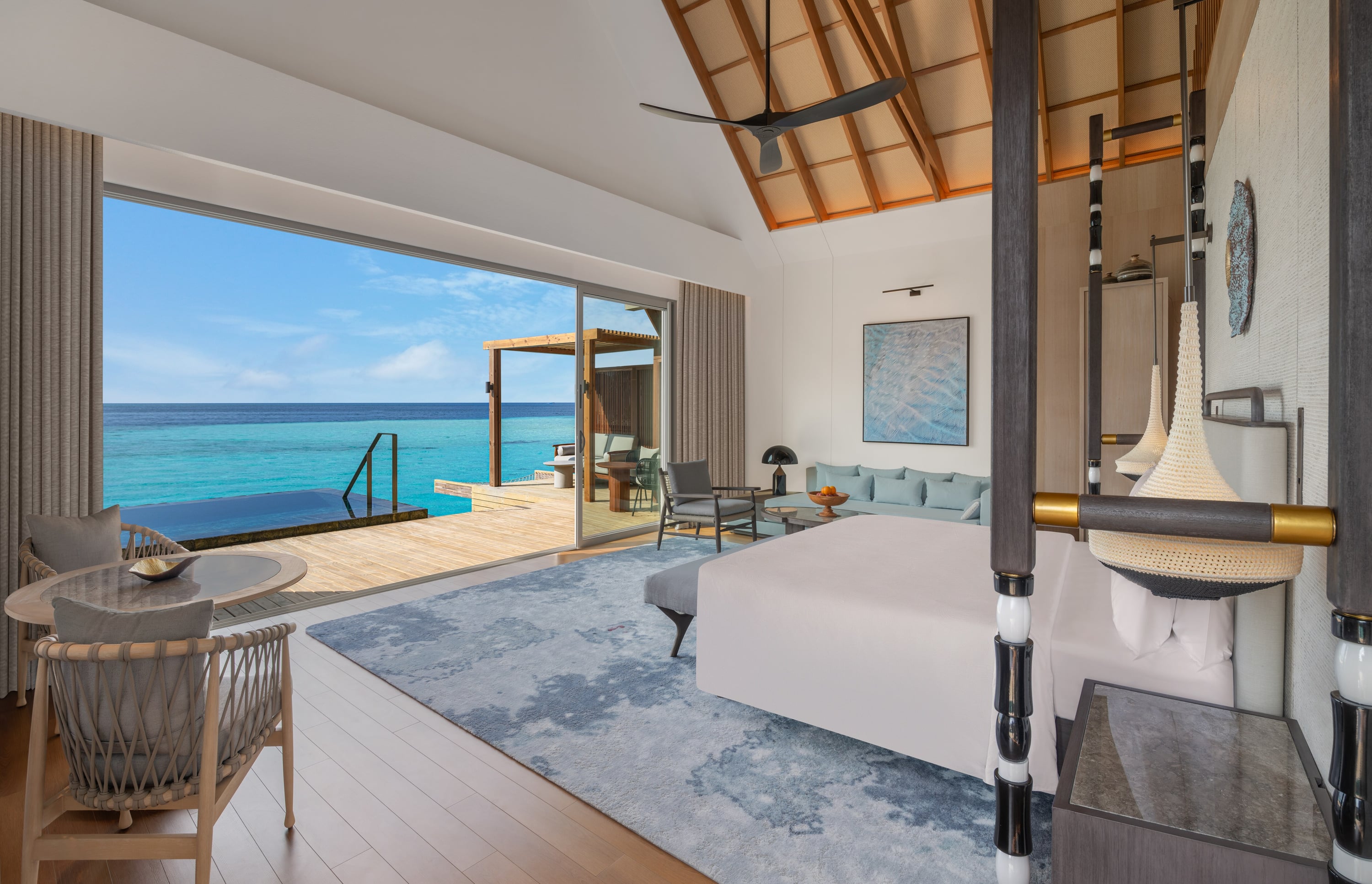 Overwater villa bedroom at JW Marriott Maldives Kaafu Atoll Island Resort