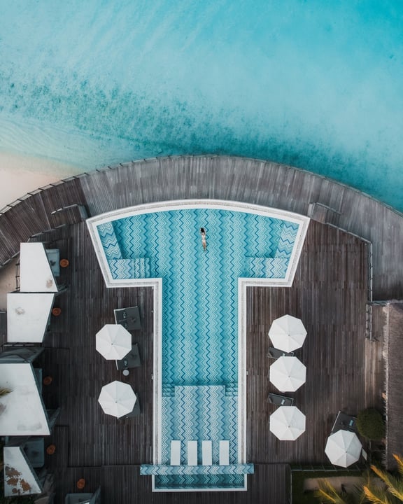 Photo by JW Marriott Maldives Resort & Spa on July 29, 2026. May be an image of chaise longue, deck chair, pool, water, outdoors, cabana and text.