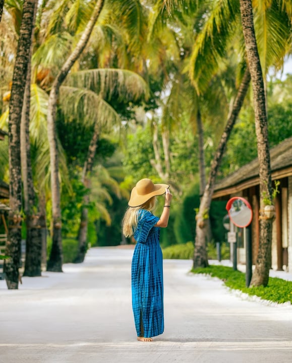 Photo by Kuredu Island Resort & Spa in Kuredu Island Resort. May be an image of headscarf, sundress, sarong, palm trees, outdoors and text.