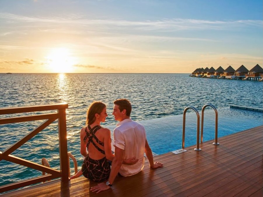 Photo by Mercure Maldives Kooddoo in Mercure Maldives Kooddoo Resort. May be an image of one or more people, people kissing, beach, cabana and text.