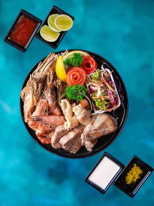 Photo by Mercure Maldives Kooddoo on July 30, 2026. May be an image of fish, platter, plate and text.
