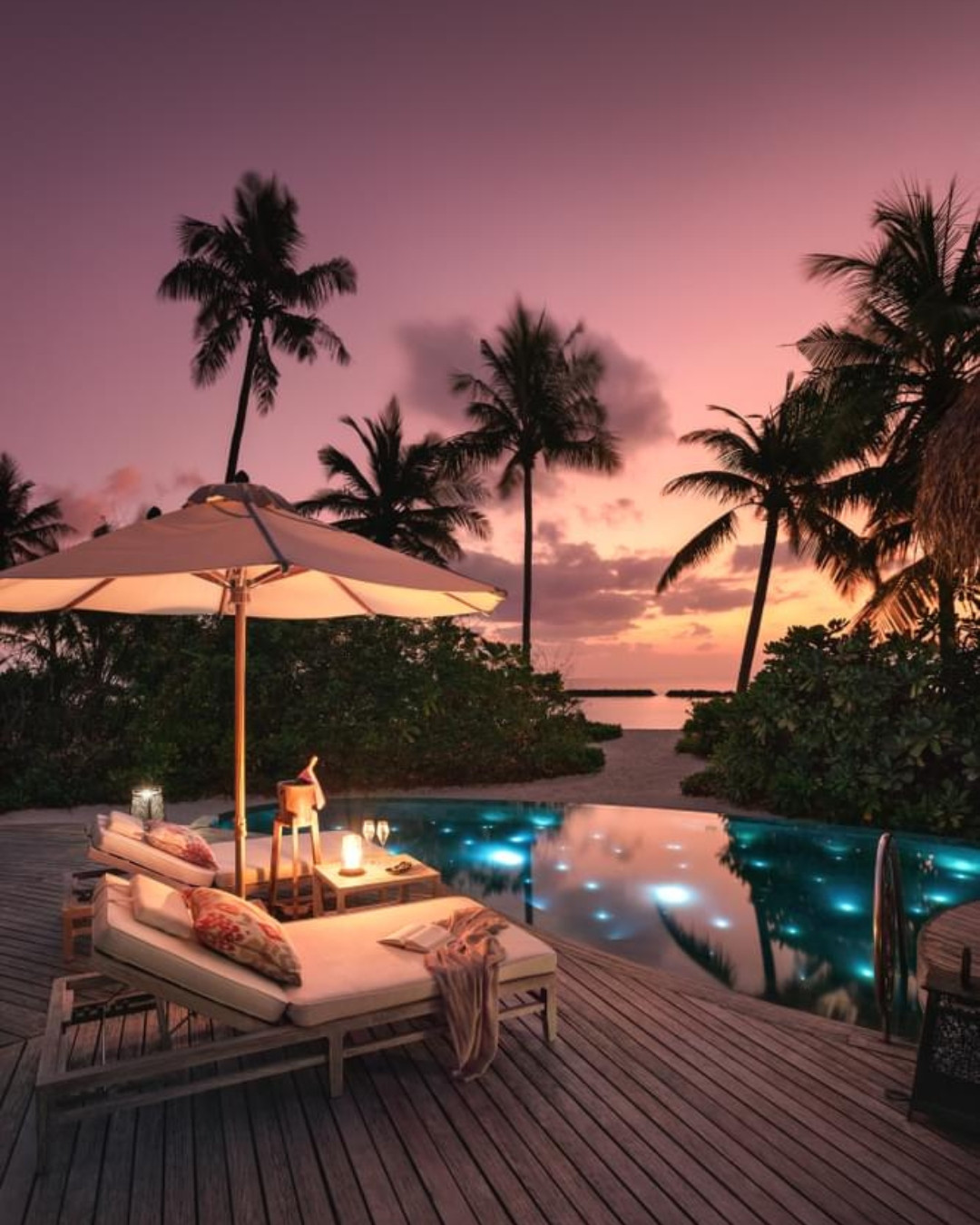 Photo by The Nautilus Maldives on August 11, 2026. May be an image of chaise longue, deck chair, twilight, pool, ocean, horizon, palm trees, cabana and text.