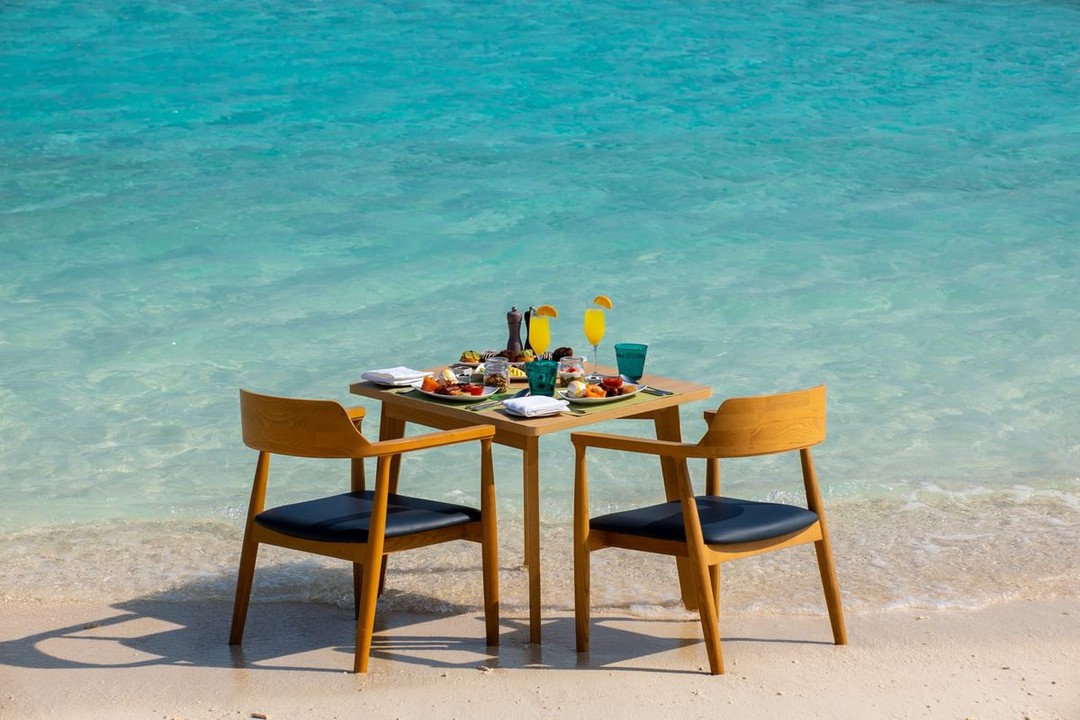 Photo by Nova Maldives on August 12, 2026. May be an image of dining table, deck chair, beach, ocean and text.