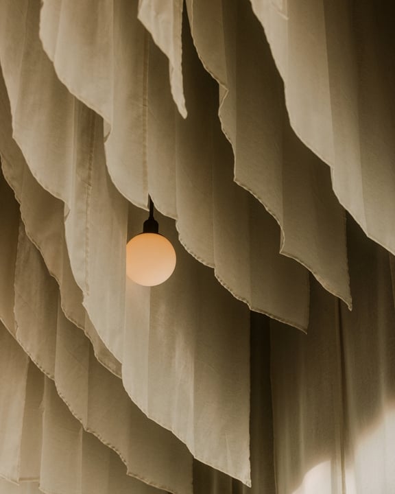 Photo shared by One&Only Reethi Rah on June 01, 2026 tagging @tapasakemaldives. May be an image of lighting, curtains, lampshade, light bulb and text.