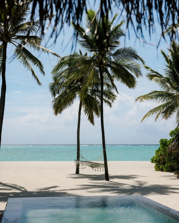 Photo by One&Only Reethi Rah in One&Only Reethi Rah, Maldives. May be an image of chaise longue, pool, beach, ocean, horizon, palm trees, cabana and text.