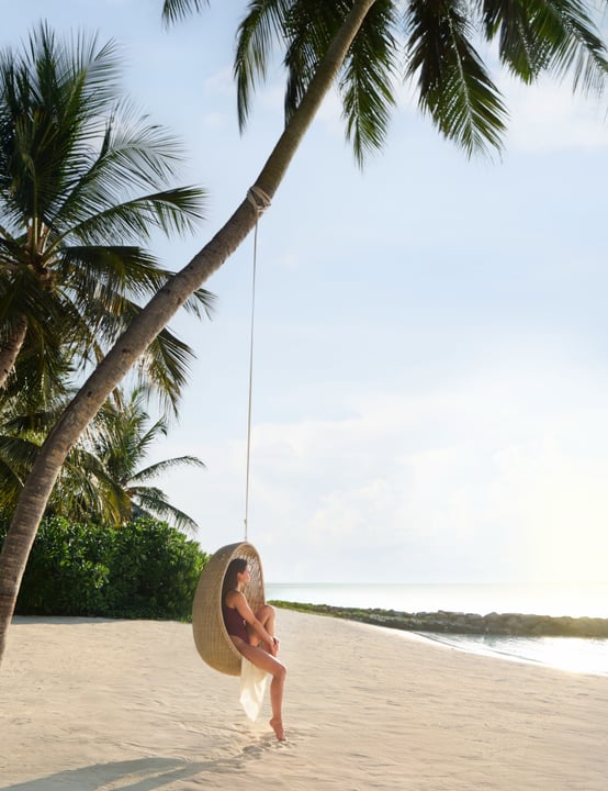Photo by The Ritz-Carlton Maldives, Fari Islands in The Ritz-Carlton Maldives, Fari Islands. May be an image of hammock, chaise longue, palm trees and text.
