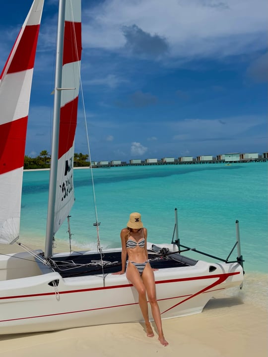 Photo shared by Rebecca Judd on June 13, 2026 tagging @triangl, @luxury.escapes, @passportcard_au, and @so.maldives. May be an image of sail, sailing boat, yacht, speedboat, ocean and text.