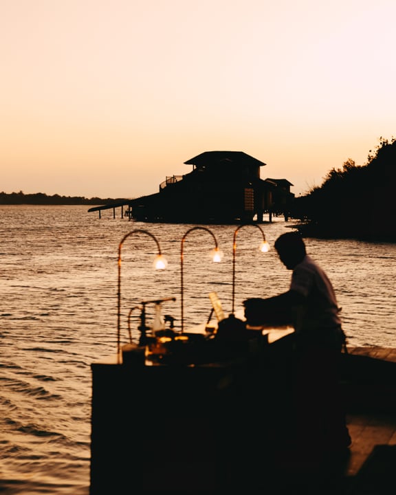 Photo shared by Soneva on July 29, 2026 tagging @sonevajaniofficial. May be an image of riverboat, lantern, twilight, houseboat, boathouse and text.