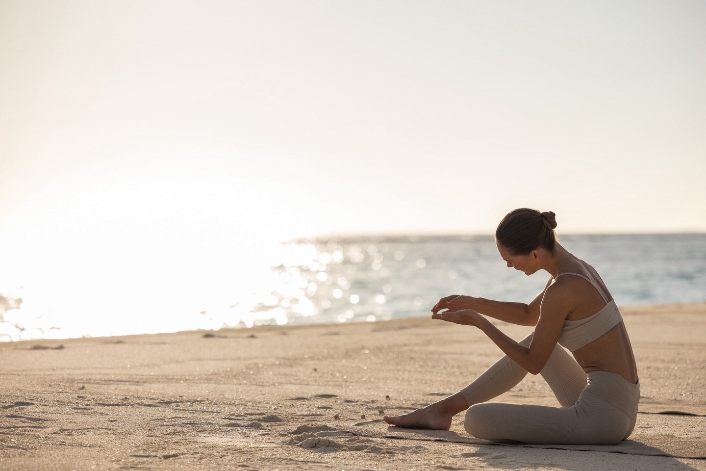 Photo by The Standard, Maldives in The Standard, Maldives. May be an image of one or more people, people practising yoga, activewear, beach and text.