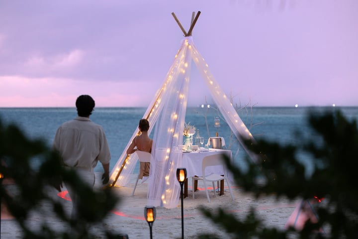 Photo by The Standard, Maldives on June 19, 2026. May be an image of boat, christmas tree, tent, lantern, yacht, twilight, night, outdoors and text.