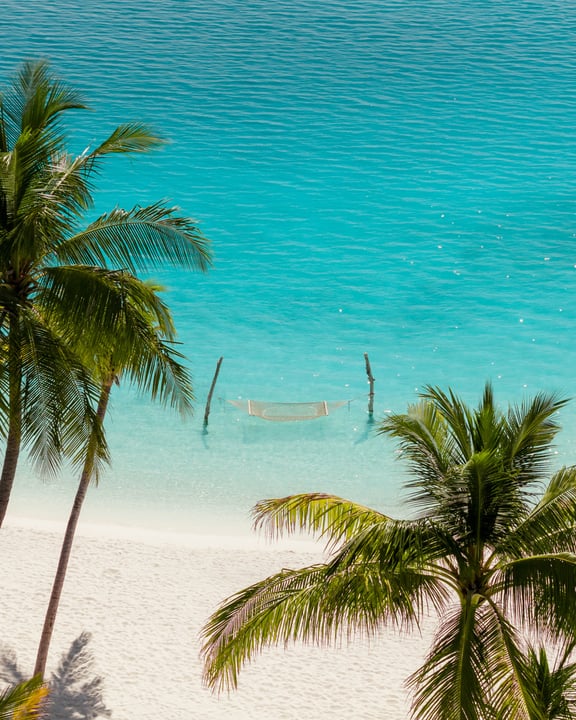 Photo by Iru Veli on June 06, 2026. May be an image of beach, body of water, palm trees and text.