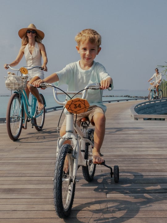 Photo by Velaa Private Island Maldives on June 13, 2026. May be an image of child, bicycle, scooter and text.