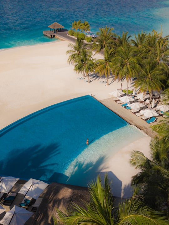 Photo by Niva Velassaru Maldives on August 12, 2026. May be an image of chaise longue, pool, cabana and text.